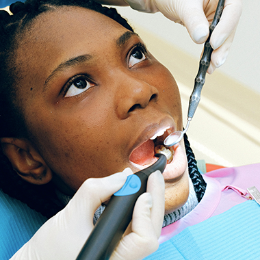 Dentist inspecting a patient's mouth