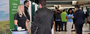 Students at a job fair talking at booths