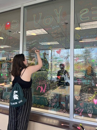 Person writing on window